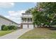 Charming two-story home featuring a covered porch with a white railing and a blooming tree in the yard at 218 South Se Ave, Atlanta, GA 30315