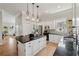Bright kitchen with white cabinets, stainless steel appliances, and an island with seating at 218 South Se Ave, Atlanta, GA 30315