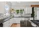 Modern kitchen with stainless steel appliances, granite countertops, kitchen island and custom backsplash at 218 South Se Ave, Atlanta, GA 30315