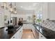 Bright kitchen features stainless steel appliances, modern tile backsplash, granite countertops and hardwood floors at 218 South Se Ave, Atlanta, GA 30315