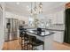 Modern kitchen with stainless steel appliances, granite countertops, kitchen island and custom backsplash at 218 South Se Ave, Atlanta, GA 30315