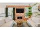 Comfortable living room featuring a brick fireplace, stylish decor, and french doors to the deck at 218 South Se Ave, Atlanta, GA 30315
