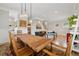 Open concept living and dining area with a view of the staircase and kitchen, featuring warm lighting at 218 South Se Ave, Atlanta, GA 30315