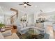 Bright and airy living room featuring hardwood floors, a large sectional sofa, and an open floor plan to the kitchen at 218 South Se Ave, Atlanta, GA 30315