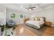 Inviting main bedroom featuring hardwood floors, a cozy sitting area, and ample natural light from the surrounding windows at 218 South Se Ave, Atlanta, GA 30315