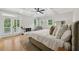 Spacious main bedroom with coffered ceilings, hardwood floors, fireplace, and french doors to a private balcony at 218 South Se Ave, Atlanta, GA 30315