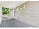 Covered porch features gray decking, white railings and a set of doors to the interior at 218 South Se Ave, Atlanta, GA 30315