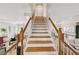 Elegant staircase with wooden steps, white risers, and beautiful white and wood railings at 218 South Se Ave, Atlanta, GA 30315
