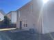 Back of home with small concrete patio, vinyl siding, and grass at 3116 Leyland Ct, Decatur, GA 30034