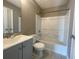 Standard bathroom with a grey vanity cabinet, tiled floors and a tub with shower at 3116 Leyland Ct, Decatur, GA 30034