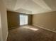 Bedroom featuring carpeted floors, tray ceiling, and natural light from the window at 3116 Leyland Ct, Decatur, GA 30034