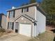 Two-story home with brick and vinyl siding, and an attached garage at 3116 Leyland Ct, Decatur, GA 30034