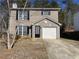 Two-story brick home with a single car garage and a neatly kept front lawn at 3116 Leyland Ct, Decatur, GA 30034