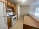 Compact kitchen featuring white appliances and oak-style cabinets at 3116 Leyland Ct, Decatur, GA 30034