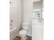 Well-lit bathroom showcasing a tub with shower, toilet, and vanity with white cabinets at 4036 Trimrose Ct, Atlanta, GA 30349