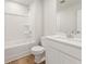 Bathroom with single sink vanity, modern fixtures, a tub with shower, and wood-look flooring at 4036 Trimrose Ct, Atlanta, GA 30349