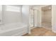 Well-lit bathroom with a tub, separate shower, and view to a walk-in closet at 4036 Trimrose Ct, Atlanta, GA 30349