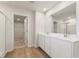 Bathroom featuring double sinks, a large mirror, and a separate shower at 4036 Trimrose Ct, Atlanta, GA 30349