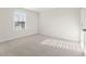 Well-lit bedroom with neutral carpet, a window with blinds, and a closet at 4036 Trimrose Ct, Atlanta, GA 30349