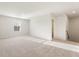 Large bonus room with neutral carpet, a window for natural light, and access to stairs at 4036 Trimrose Ct, Atlanta, GA 30349