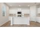 Modern kitchen featuring an island, granite countertops, white cabinets, and stainless steel appliances at 4036 Trimrose Ct, Atlanta, GA 30349