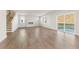 Spacious living room features wood-look flooring, a fireplace, and sliding glass doors to the backyard at 4036 Trimrose Ct, Atlanta, GA 30349
