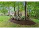 Charming backyard featuring mature trees, garden, and lush green lawn at 4246 N Mountain Ne Rd, Marietta, GA 30066