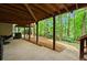 Lush backyard featuring mature trees and a play area below the deck at 4246 N Mountain Ne Rd, Marietta, GA 30066