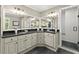 Dual sink bathroom vanity with granite countertops, walk-in shower with white subway tile and grey flooring at 4246 N Mountain Ne Rd, Marietta, GA 30066