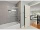 Bathroom featuring shower and tub combination with tiled walls and floors at 4246 N Mountain Ne Rd, Marietta, GA 30066