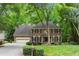 Charming brick home with mature trees, manicured lawn, and a two-car garage at 4246 N Mountain Ne Rd, Marietta, GA 30066