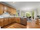 Well-lit kitchen features wooden cabinets, stainless steel appliances, and a breakfast area with a view of the lush surroundings at 4246 N Mountain Ne Rd, Marietta, GA 30066