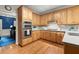 Charming kitchen showcases light wood cabinetry, modern appliances, and an adjacent room with a bright blue wall at 4246 N Mountain Ne Rd, Marietta, GA 30066