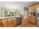 Inviting kitchen with stainless steel appliances, light wood cabinets and a view of the natural surroundings at 4246 N Mountain Ne Rd, Marietta, GA 30066