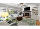 Bright living room with fireplace, built-in shelves, and large windows at 4246 N Mountain Ne Rd, Marietta, GA 30066