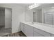 Bright bathroom features double vanity with white cabinets and ample counter space at 436 Corricella Ct, Mcdonough, GA 30253