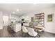 Open-concept kitchen and dining area with updated lighting and hardwood flooring at 11408 Gray Branch Dr, Lawrenceville, GA 30045