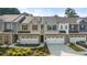 Attractive townhomes featuring mixed materials and attached garages with nice landscaping at 11408 Gray Branch Dr, Lawrenceville, GA 30045