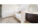 Relaxing bathroom with soaking tub and vanity featuring a dark wood cabinet at 212 Jetta Cir, Mcdonough, GA 30253