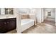 Stylish bathroom with soaking tub, dark vanity, and a combination of tile and vinyl flooring at 212 Jetta Cir, Mcdonough, GA 30253