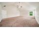 Large primary bedroom with vaulted ceiling, ceiling fan, and natural light from the window at 212 Jetta Cir, Mcdonough, GA 30253