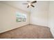 Bright bedroom with carpeted floors and a ceiling fan, offering ample natural light through a window at 212 Jetta Cir, Mcdonough, GA 30253