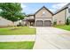 Charming two-story home featuring a manicured lawn, a two-car garage, and a welcoming entrance at 212 Jetta Cir, Mcdonough, GA 30253