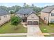 Inviting two-story home with a well-maintained lawn, two-car garage and stone-accented entryway at 212 Jetta Cir, Mcdonough, GA 30253