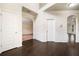 Spacious foyer boasts dark hardwood floors, elegant trim, and arched doorways leading to other rooms at 212 Jetta Cir, Mcdonough, GA 30253
