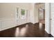 Bright foyer featuring gleaming hardwood floors, a front door with sidelights and decorative trim at 212 Jetta Cir, Mcdonough, GA 30253