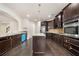 Modern kitchen equipped with dark cabinetry, stainless steel appliances, and granite countertops for meal preparation at 212 Jetta Cir, Mcdonough, GA 30253