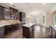 Modern kitchen with dark wood cabinets, granite countertops, stainless steel appliances, and center island at 212 Jetta Cir, Mcdonough, GA 30253