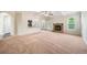Bright and airy living room with a cozy stone fireplace and open access to the kitchen and dining areas at 212 Jetta Cir, Mcdonough, GA 30253