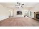 Sunlit living room with an open layout, stone fireplace, and seamless access to the kitchen and dining spaces at 212 Jetta Cir, Mcdonough, GA 30253